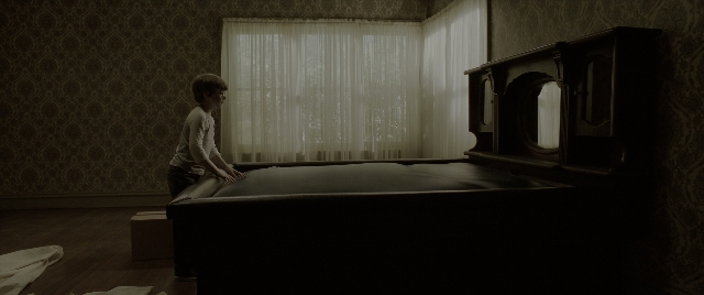 Wide shot frame from The Conjuring: The Devil Made Me Do It — standing, room, bed