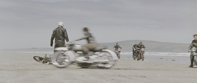 Wide shot frame from The World's Fastest Indian — bicycle, motorcycle, wheel
