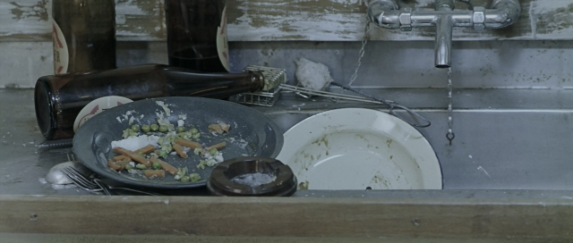 Wide shot frame from The World's Fastest Indian — plate, kitchen, food