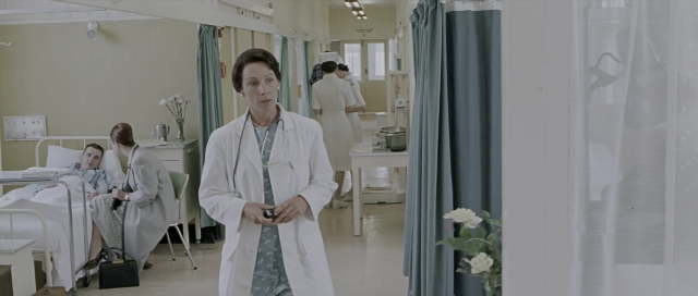 Wide shot frame from The World's Fastest Indian — room, bed, coat