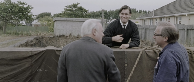 Wide shot frame from The World's Fastest Indian — standing, dialogue, tie