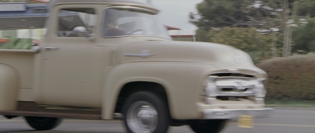 Wide shot frame from The World's Fastest Indian — sitting, bed, street