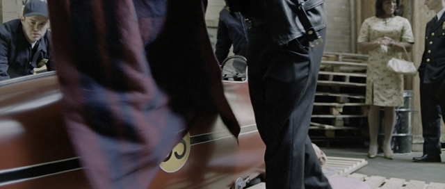 Wide shot frame from The World's Fastest Indian — standing, room, uniform