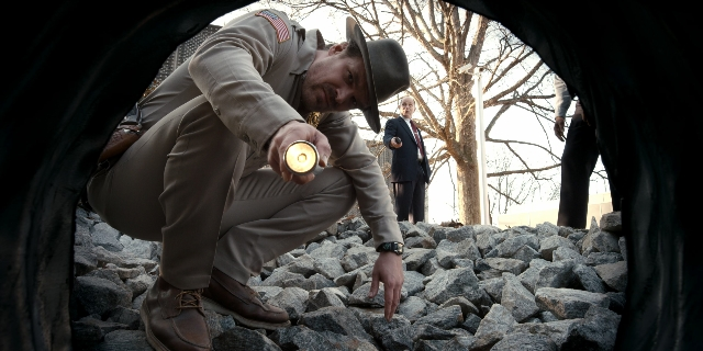 Wide shot frame from Stranger Things — standing, hat, uniform