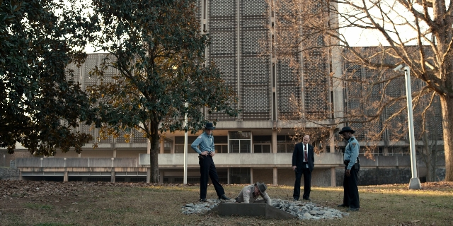 Wide shot frame from Stranger Things — standing, dialogue, person