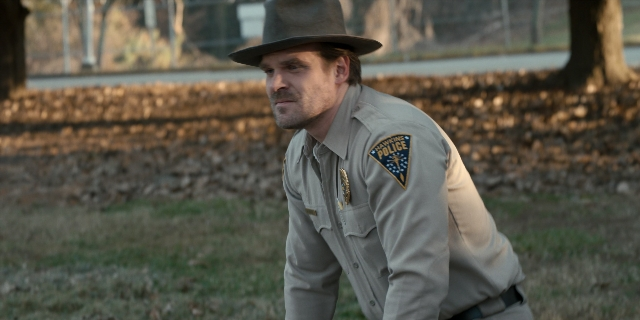 Wide shot frame from Stranger Things — standing, hat, uniform