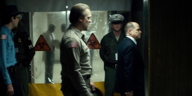 Wide shot frame from Stranger Things — standing, room, door