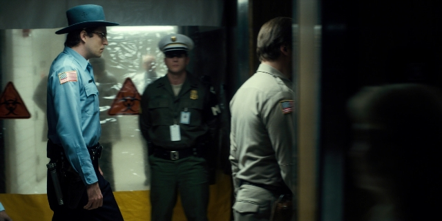 Medium shot frame from Stranger Things — standing, dialogue, phone