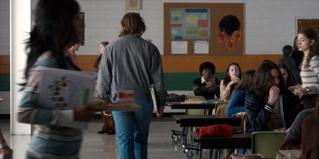 Wide shot frame from Stranger Things — sitting, standing, room