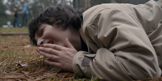 Wide shot frame from Stranger Things — person, human face, human hand