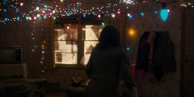 Wide shot frame from Stranger Things — book, standing, room