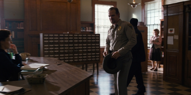 Wide shot frame from Stranger Things — sitting, standing, walking