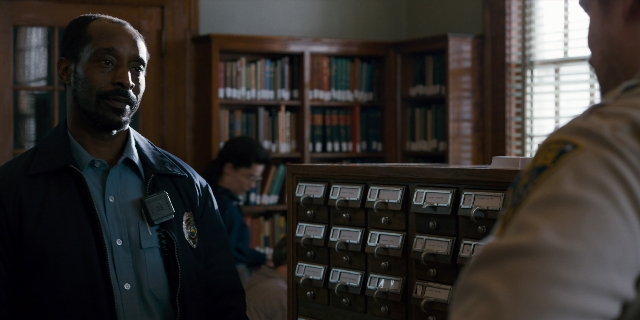 Wide shot frame from Stranger Things — book, standing, room
