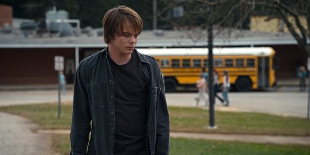Wide shot frame from Stranger Things — standing, walking, street