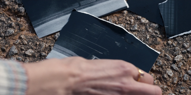 Wide shot frame from Stranger Things — hand, shirt, person