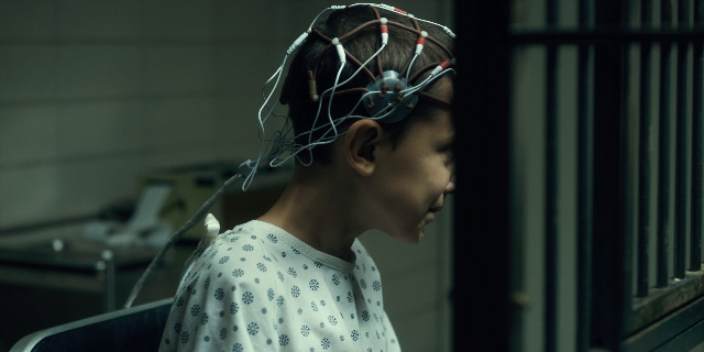 Wide shot frame from Stranger Things — sitting, room, bed