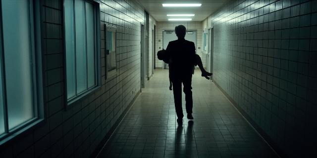 Wide shot frame from Stranger Things — walking, door, person