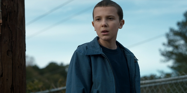 Wide shot frame from Stranger Things — standing, shirt, jacket