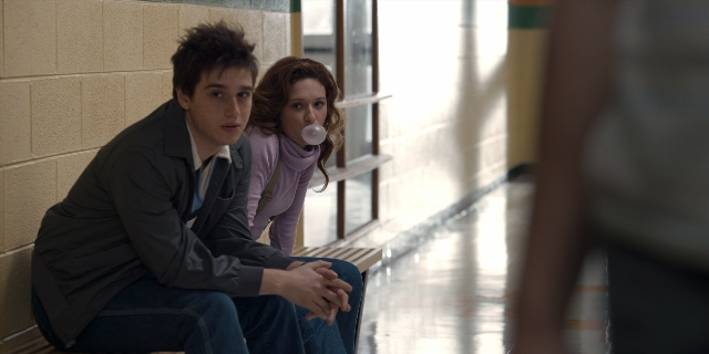Wide shot frame from Stranger Things — sitting, hand, hair