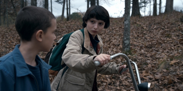Wide shot frame from Stranger Things — standing, jacket, face