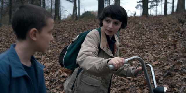 Wide shot frame from Stranger Things — standing, jacket, face