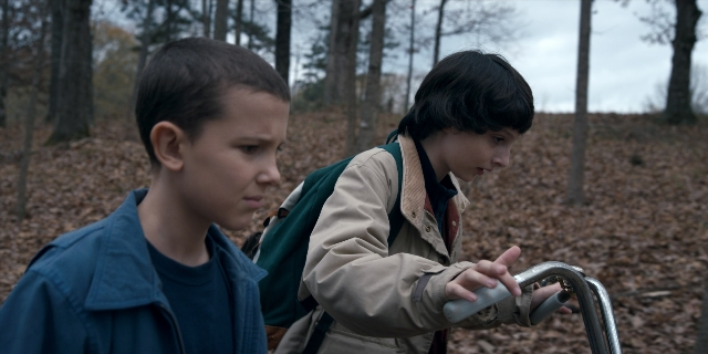 Medium shot frame from Stranger Things — standing, jacket, face