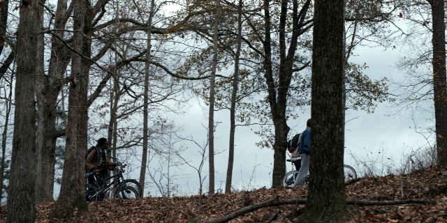 Wide shot frame from Stranger Things — standing, bicycle, person