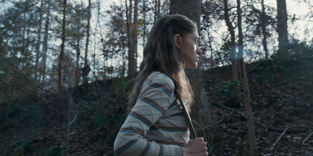 Wide shot frame from Stranger Things — standing, face, hair