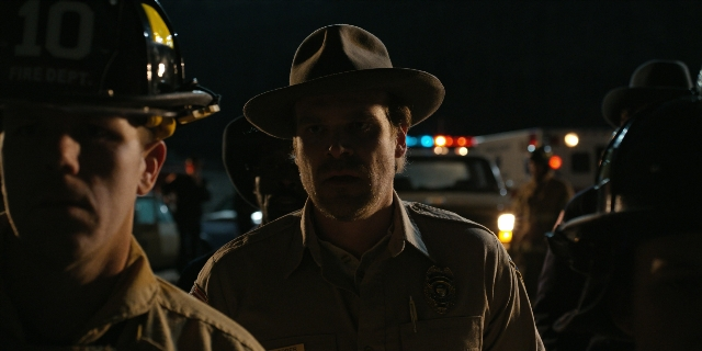 Medium shot frame from Stranger Things — standing, hat, uniform