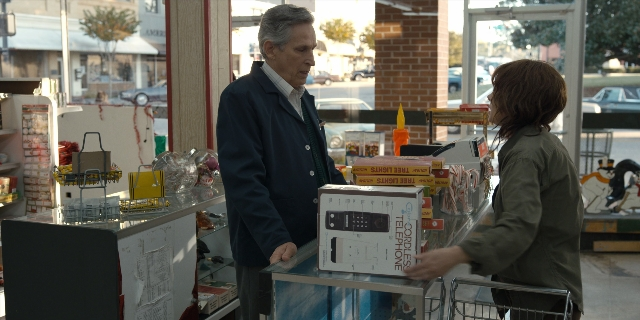 Wide shot frame from Stranger Things — standing, street, face
