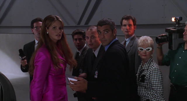 Wide shot frame from Batman & Robin — standing, room, dialogue