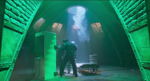 Wide shot frame from Batman & Robin — standing, room, bed