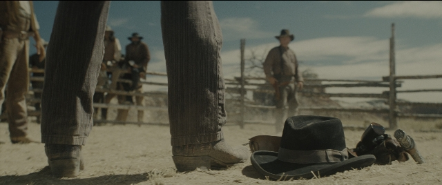 Wide shot frame from The Magnificent Seven — standing, hat, person