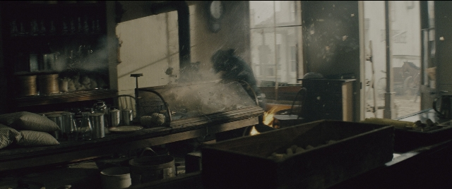 Wide shot frame from The Magnificent Seven — standing, room, kitchen