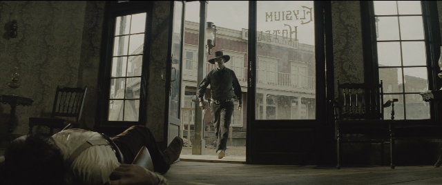 Medium shot frame from The Magnificent Seven — walking, room, table