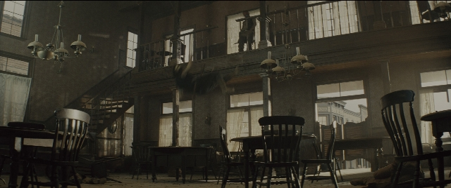 Wide shot frame from The Magnificent Seven — room, table, house