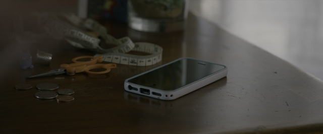 Frame from 10 Cloverfield Lane — room, table, phone