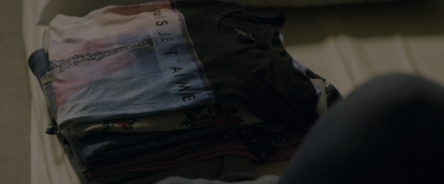 Wide shot frame from 10 Cloverfield Lane — bed, shirt, trousers