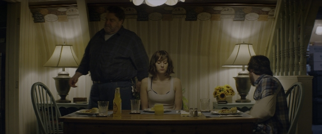 Wide shot frame from 10 Cloverfield Lane — sitting, standing, room