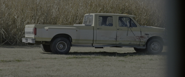 Wide shot frame from 10 Cloverfield Lane — bed, truck, wheel