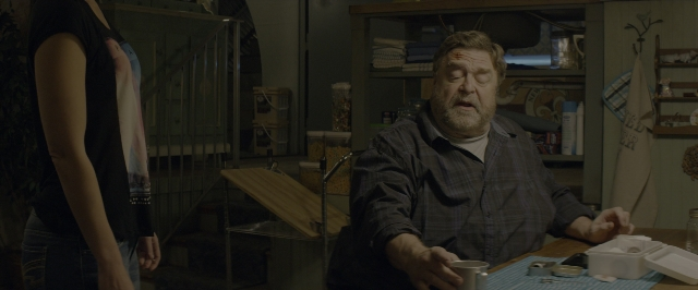 Wide shot frame from 10 Cloverfield Lane — sitting, standing, room