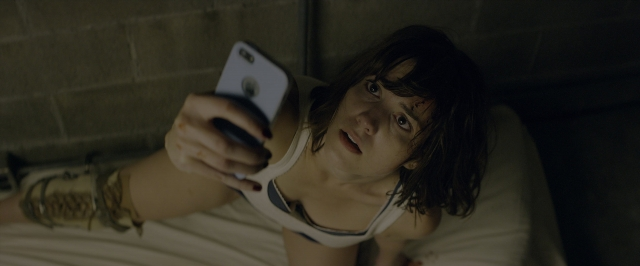 Frame from 10 Cloverfield Lane — bed, phone, hand