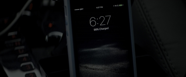 Wide shot frame from 10 Cloverfield Lane — phone, car, digital clock