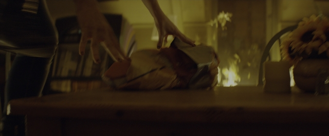 Wide shot frame from 10 Cloverfield Lane — room, table, shirt