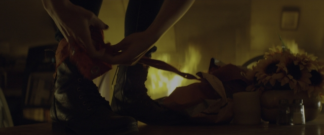 Wide shot frame from 10 Cloverfield Lane — standing, room, table