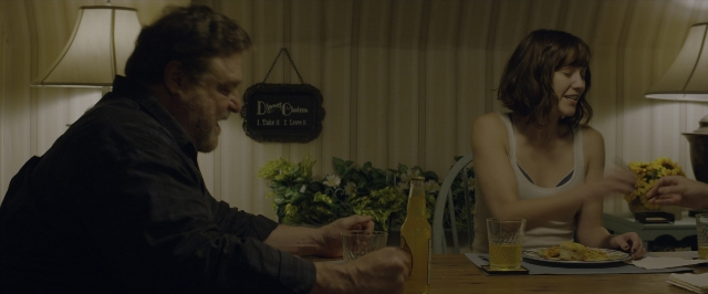 Wide shot frame from 10 Cloverfield Lane — sitting, plate, room