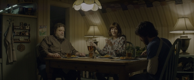 Wide shot frame from 10 Cloverfield Lane — sitting, table, dialogue