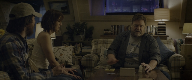 Wide shot frame from 10 Cloverfield Lane — sitting, room, table