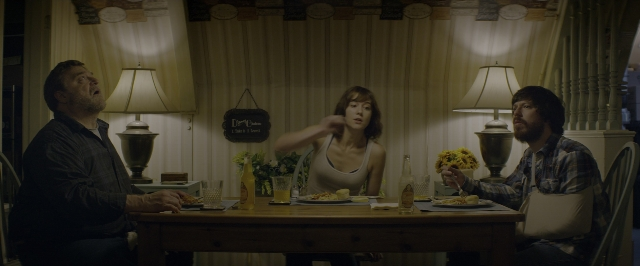 Wide shot frame from 10 Cloverfield Lane — sitting, room, table