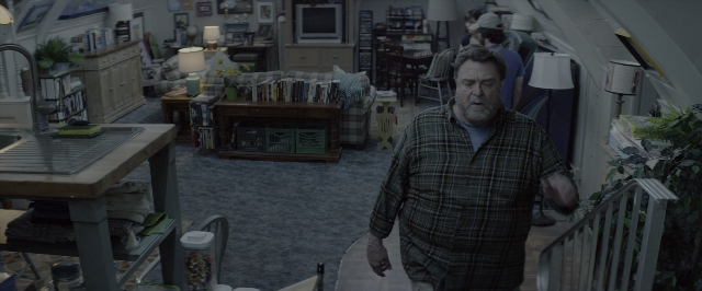 Wide shot frame from 10 Cloverfield Lane — walking, room, table